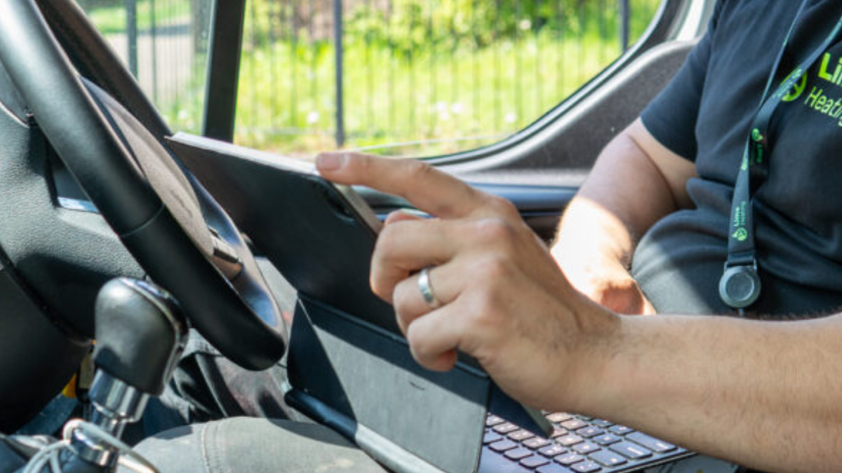 A worker from Lime Heating on an Ipad