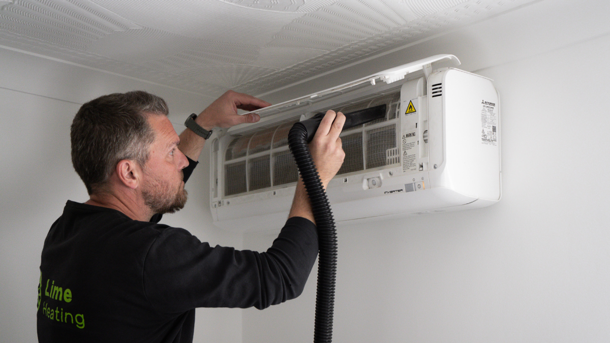 A Lime Heating worker fixing an aircon
