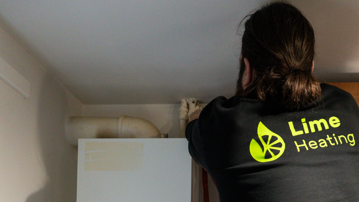 A Lime Heating worker fixing a boiler