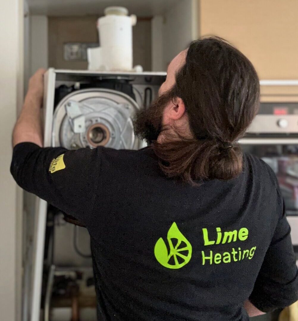 Lime Heating engineer installing a gas boiler